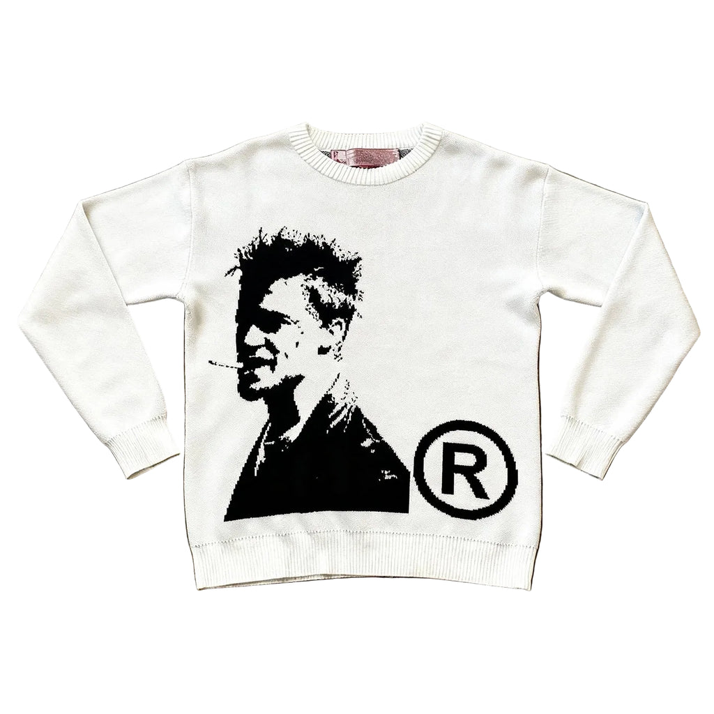 White sweatshirt with a graphic design on a textured brown surface