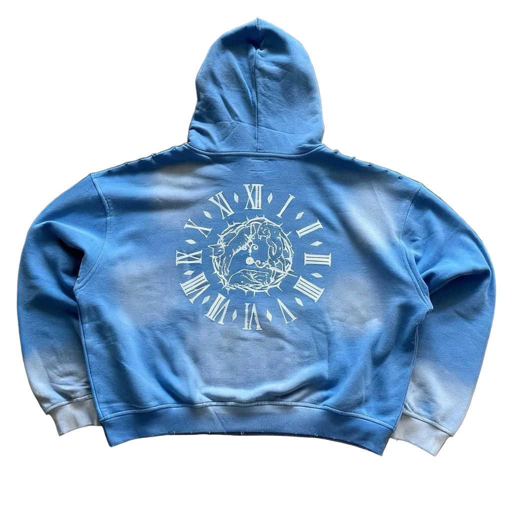 Blue hoodie with a white graphic design on the back against a brown background