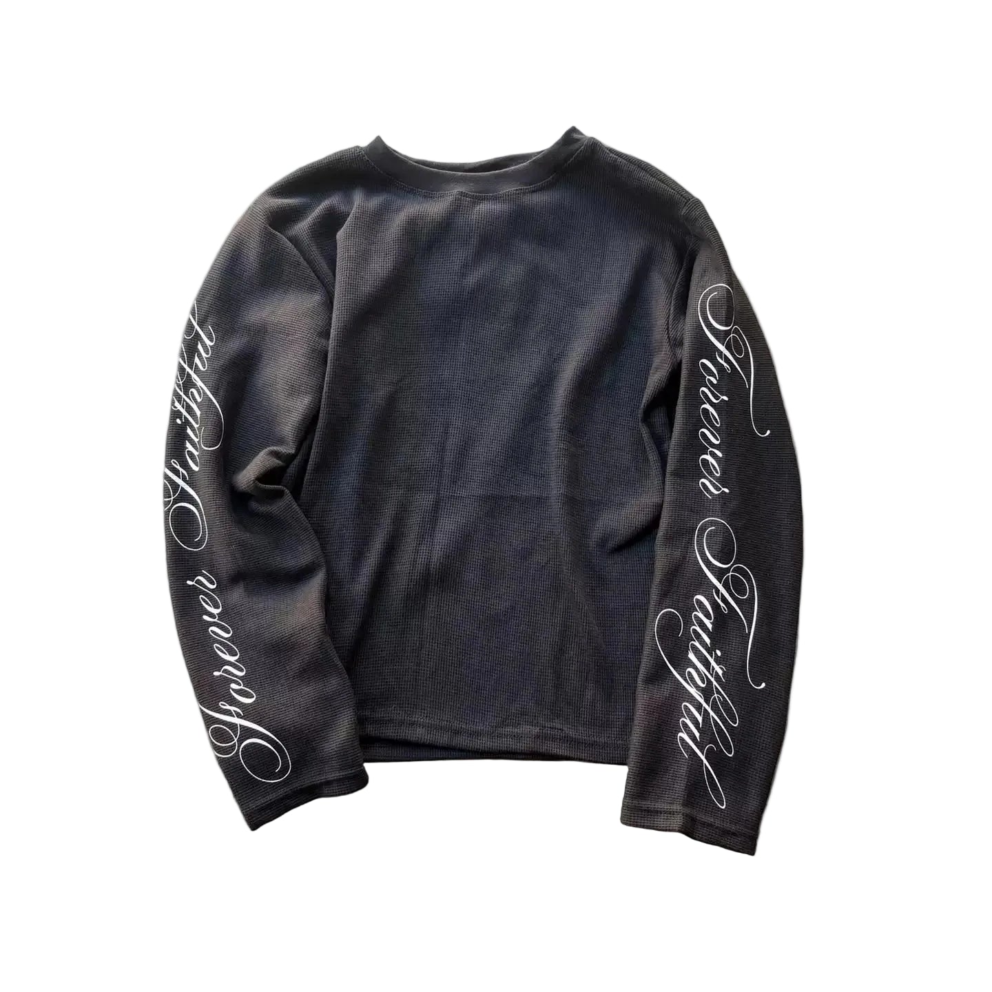 Black long-sleeve shirt with white text on a gray concrete surface