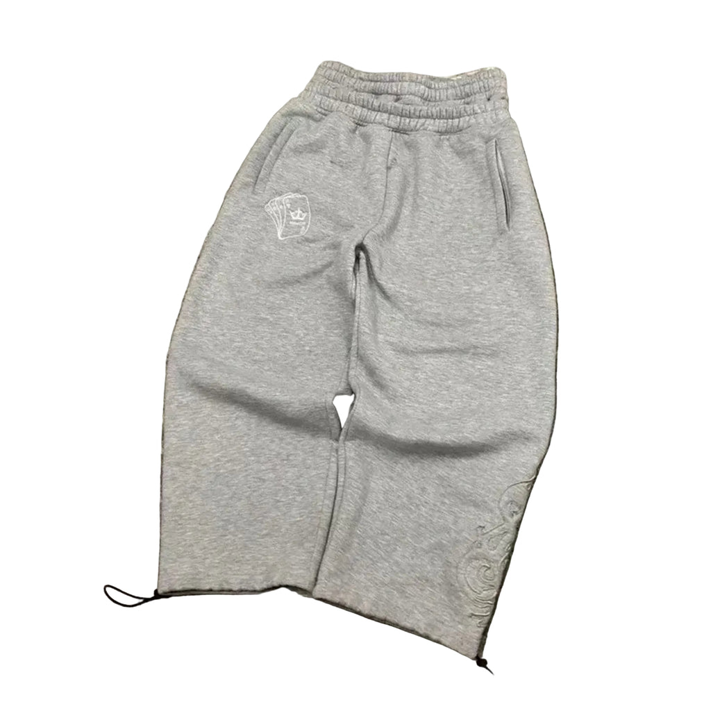 Gray sweatpants with a small logo on a concrete surface