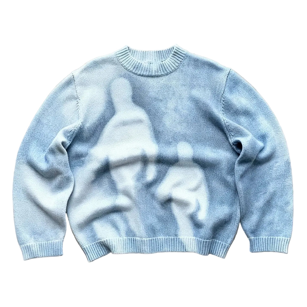 Light blue sweater with a subtle pattern on a brown surface