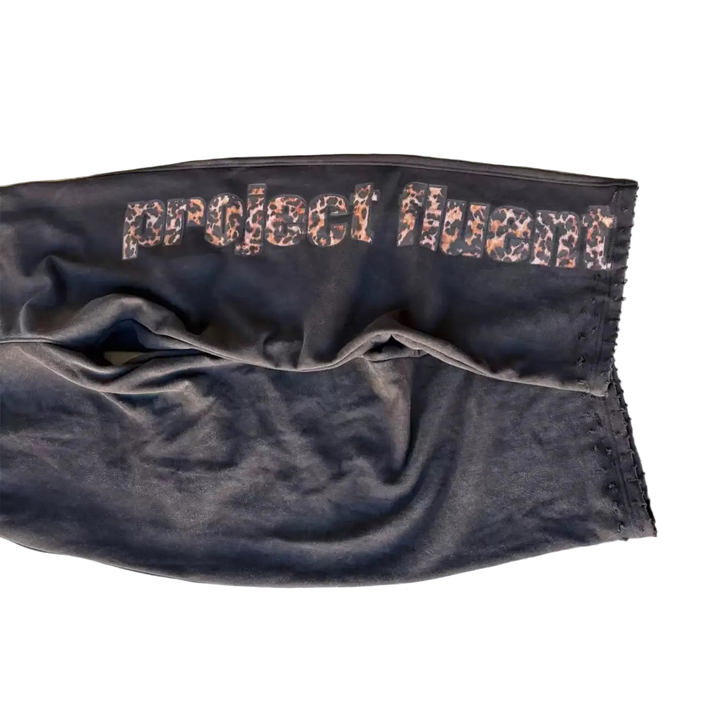 Dark fabric with 'project huxent' text on a concrete surface