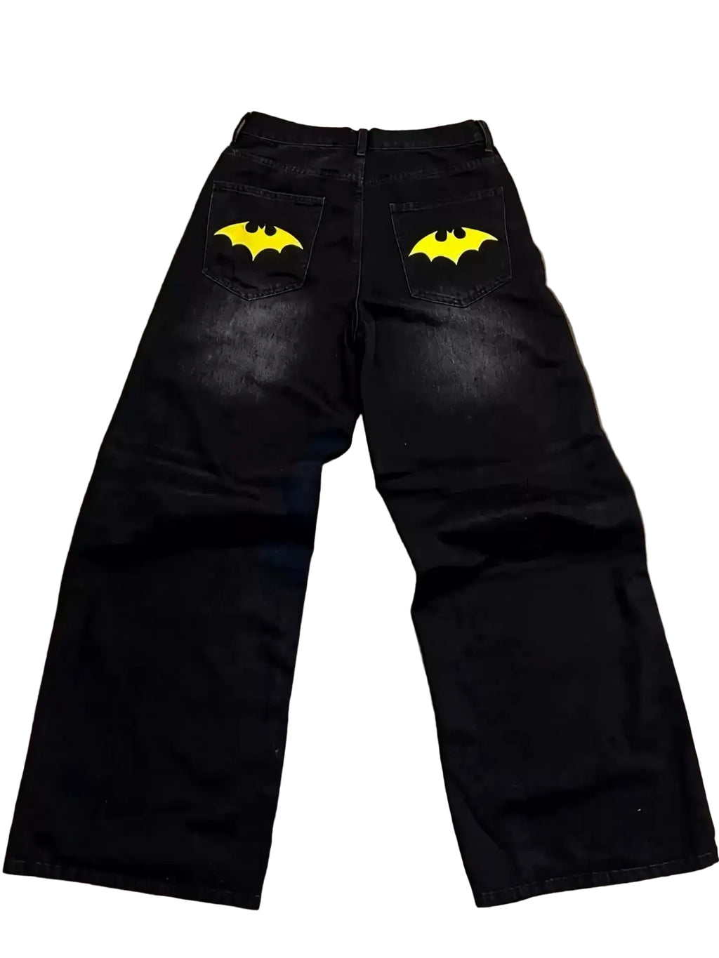 Black pants with yellow bat logos on a textured surface